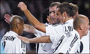 Roberto Carlos (left) is congratulated by Zinedine Zidane and Raul among others