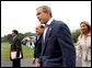 Flanked by interpreters, President George W. Bush and Italian Prime Minister Silvio Berlusconi leave a news conference after Berlusconi's arrival at Camp David, Saturday, Sept. 14, 2002. WHITE HOUSE PHOTO BY ERIC DRAPER White House photo by Eric Draper.