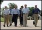 After talking with the press, President George W. Bush walks with his economic advisorsat his ranchin Crawford, Texas, Wednesday, August 13, 2003. Pictured are, from left,Director of the Office of Management and Budget Josh Bolten, Assistant to the President for Economic Policy Stephen Friedman, Secretary of Commerce Don Evans, Secretary of Labor Elaine Chao and Secretary of the Treasury John Snow. White House photo by Susan Sterner.