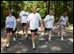 President George W. Bush and First Lady Laura Bush complete a four mile walk with brother Marvin Bush, left, Chief of Staff Andy Card and wife Kathleene after undergoing a colorectal screening procedure at Camp David, Saturday morning, June 29. White House photo by Eric Draper.