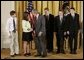 President George W. Bush congratulates students of South Cache 8th and 9th Grade Center in Hyrum, Utah, on receiving the Presidents Environmental Youth Award in the East Room of the White House April 21, 2005. Members include, from left to right, Parker Hellstern, 14, Tana Hellstern, 16, Aaron Lusk, 15, Bryan Miller, 14, and Jason Newhall, 14. White House photo by Paul Morse