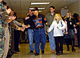 Marine Lance Cpl. Zach Fincannon (black T-shirt and hat) shakes hands with well wishers upon his entrance to the Pentagon Dec. 3, 2004. Hundreds of Pentagon employees lined the hallways to applaud wounded service members from Walter Reed Army Medical Center visiting the Pentagon. U.S. Army photo by Staff Sgt. Carmen Burgess