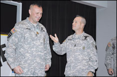 Command Sgt. Maj. Jack Peters introduces Sgt. 1st Class Michael Salter during a welcome home ceremony. During his deployment, Peters served as a mentor to the Afghanistan National Recruiting Command.