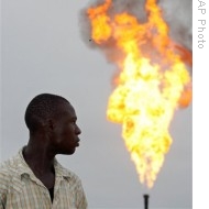A resident of Nigeria's oil-rich delta region looks at flames from a gas flare belonging to Italian oil company Agip in Ebocha, Nigeria (File)