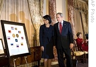 Secretary of State Condoleezza Rice (l) presents President George Bush with a memento displaying the flags of European nations that entered NATO during his presidency, 15 Jan 2009