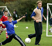 Prince William plays football with young people in London