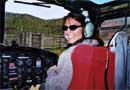 DOC staff member sitting in a helicopter used for aerial possum control, Coromandel. Photo: Justine Cannon. 