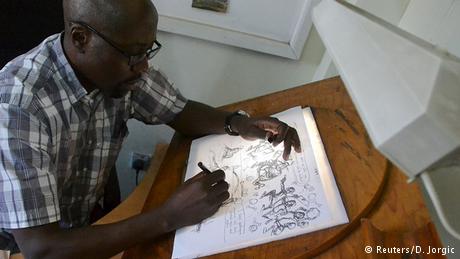 Kenyan cartoonist Godfrey Mwampembwa (Gado) working on a new cartoon © Reuters/D. Jorgic