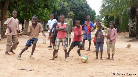 Kids play football on the streets of Guinea-Bissau
